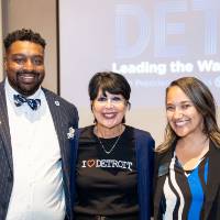 President Mantella standing with three other guests at event